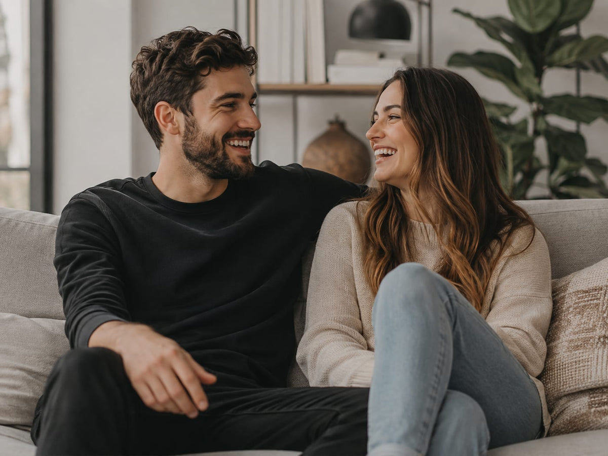 Man with a grown groomed beard smiling in soft indoor lifestyle light